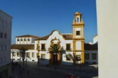 a large white building with a clock tower at APARTAMENTO SANTA MARÍA in Cádiz