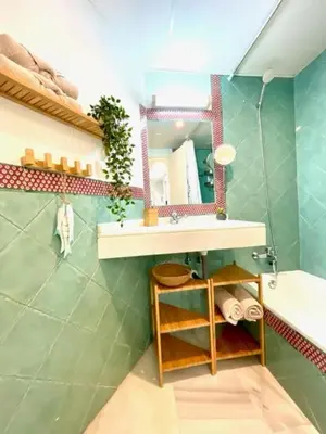 a bathroom with a sink and a mirror and a tub at GATU La Joya Escondida in El Puerto de Santa María