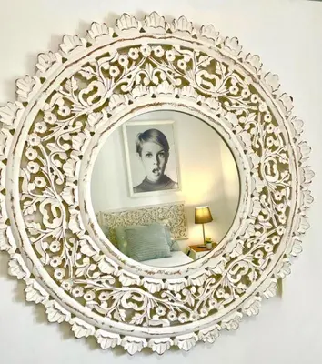 a white mirror hanging on a wall in a bedroom at GATU La Joya Escondida in El Puerto de Santa María