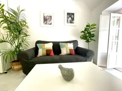 a living room with a couch and a table at GATU La Joya Escondida in El Puerto de Santa María