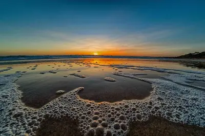 an aerial view of the beach at sunset at GATU La Joya Escondida in El Puerto de Santa María