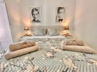 a large bed in a bedroom with two beds at GATU La Joya Escondida in El Puerto de Santa María