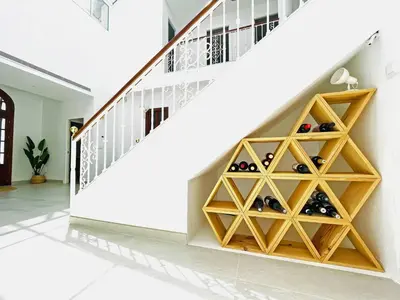 a room with a wine cellar under a staircase at Villa Velero - Ole Solutions in Sanlúcar de Barrameda