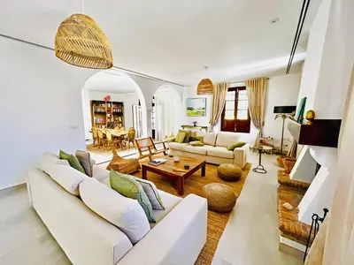 a living room with white furniture and a table at Villa Velero - Ole Solutions in Sanlúcar de Barrameda