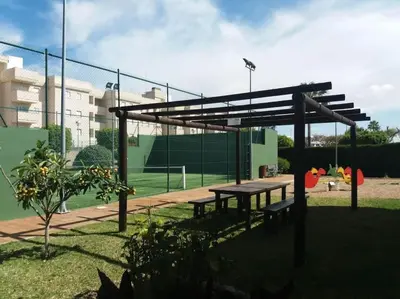 a park with a picnic table and a tennis court at Puerta de Doñana: Playa y centro a un paso. in Sanlúcar de Barrameda