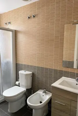 a bathroom with a toilet and a sink at Puerta de Doñana: Playa y centro a un paso. in Sanlúcar de Barrameda
