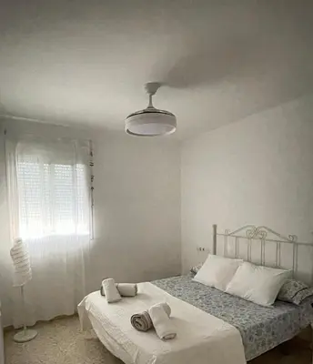 a bedroom with a bed with towels on it at Puerta de Doñana: Playa y centro a un paso. in Sanlúcar de Barrameda
