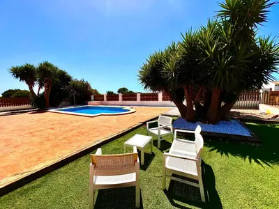 a group of chairs and a swimming pool at Casa Con Encanto 2 SOLO FAMILIAS in Conil de la Frontera