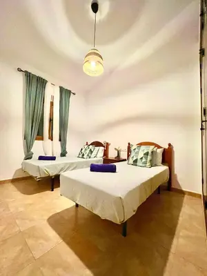 a room with two beds in a room at Casa Con Encanto 2 SOLO FAMILIAS in Conil de la Frontera