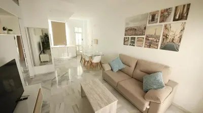 a living room with a couch and a table at Allo Apartments Larga Hideaway Parking Centro 2 Habitaciones in Jerez de la Frontera