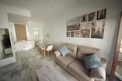 a living room with a couch and a table at Allo Apartments Larga Hideaway Parking Centro 2 Habitaciones in Jerez de la Frontera