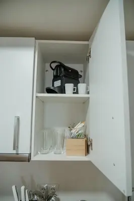 a kitchen cabinet with cups and dishes on it at Olivar de Belén in Jerez de la Frontera
