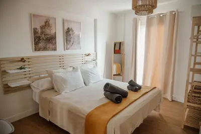 a bedroom with a bed with two pillows on it at Olivar de Belén in Jerez de la Frontera