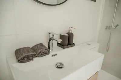 a bathroom sink with two towels and a shower at Olivar de Belén in Jerez de la Frontera