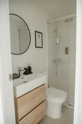 a bathroom with a sink and a toilet and a mirror at Olivar de Belén in Jerez de la Frontera