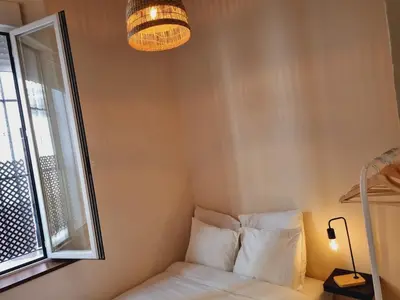 a small room with a bed and a window at AUJADA CENTRO in Cádiz