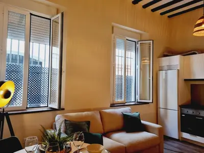 a living room with a couch and some windows at AUJADA CENTRO in Cádiz