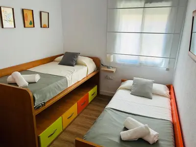 a bedroom with two beds and a window at Rinconcito Gaditano con GARAJE al lado de la PLAYA in Cádiz