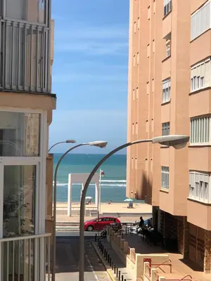 a view of the beach from between two buildings at Rinconcito Gaditano con GARAJE al lado de la PLAYA in Cádiz
