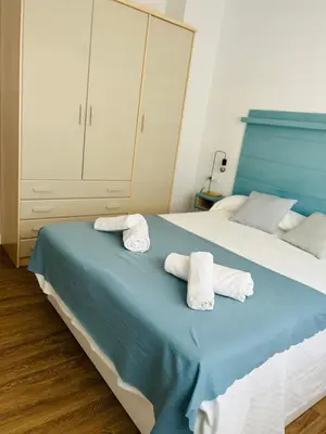 a bedroom with two towels on a bed at Rinconcito Gaditano con GARAJE al lado de la PLAYA in Cádiz