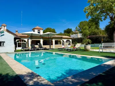 a swimming pool in front of a house at VILLA MACARENA in Espera