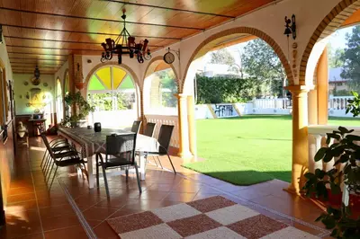 a dining room with a table and chairs in a house at VILLA MACARENA in Espera