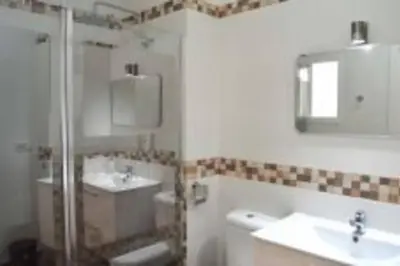 a bathroom with a shower and a sink and a toilet at APARTAMENTO VEEDOR BULEVAR DE LOS SUEÑOS in Cádiz