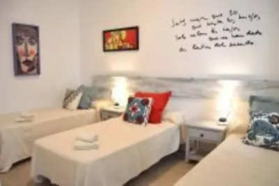 a living room with two beds and a couch at APARTAMENTO VEEDOR BULEVAR DE LOS SUEÑOS in Cádiz