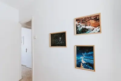 a wall with three framed paintings on it at Apartamento Valdés - Ole Solutions in El Puerto de Santa María