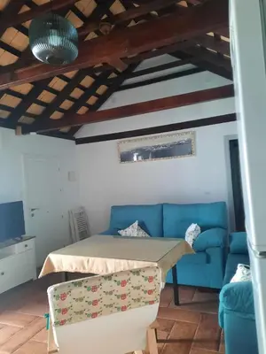 a living room with a blue couch and a table at El rincón de Manolita #3 in Bornos