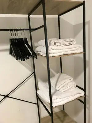 a black rack with white towels on it at El rincón de Manolita #3 in Bornos