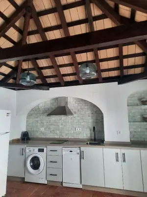 a kitchen with a sink and a washing machine at El rincón de Manolita #3 in Bornos