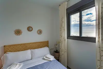 a bedroom with a bed and a window at POSEIDON Beach Apartment & parking by Cadiz4Rentals in Cádiz