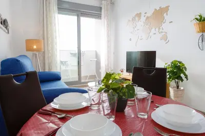 a dining room table with plates and dishes on it at POSEIDON Beach Apartment & parking by Cadiz4Rentals in Cádiz