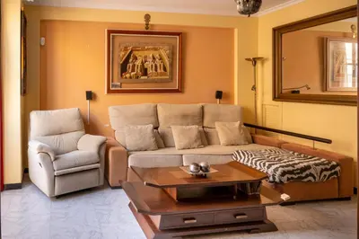 a living room with a couch and a chair at Casa RECREO in Cádiz