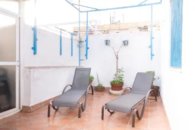 a group of chairs in a room with a tv at Casa RECREO in Cádiz