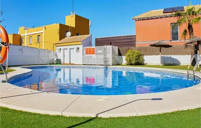 a swimming pool in front of a house at Cozy Apartment In Sanlúcar De Barrameda in Sanlúcar de Barrameda