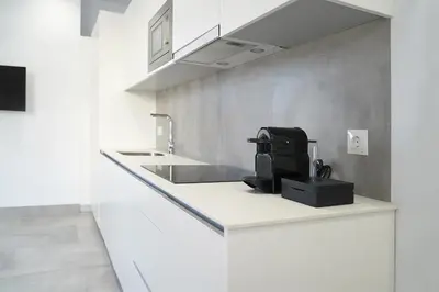 a kitchen counter with a sink and a microwave at CASA DE LA VEGA SUITES in Chiclana de la Frontera