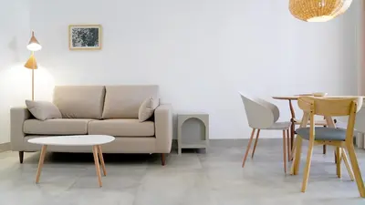a living room with a couch and a table and chairs at CASA DE LA VEGA SUITES in Chiclana de la Frontera