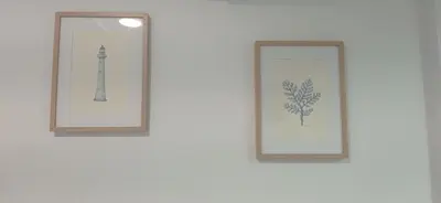 two framed pictures of a lighthouse on a wall at Geranio Chipionahome in Chipiona