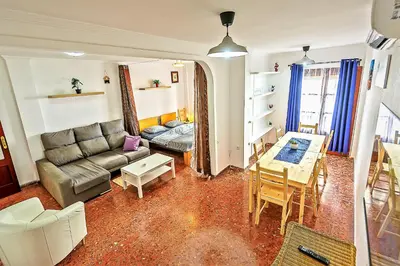 a living room with a couch and a table at Misericordia Central 4-Bedroom Apartment with Lift in El Puerto de Santa María