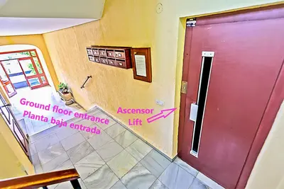 a room with a red door with a sign on it at Misericordia Central 4-Bedroom Apartment with Lift in El Puerto de Santa María