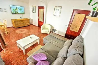 a living room with a couch and a table at Misericordia Central 4-Bedroom Apartment with Lift in El Puerto de Santa María