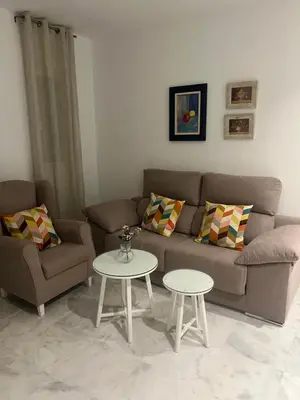 a living room with a couch and a table at Casa vacacional equipada in Lebrija