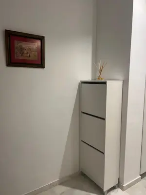 a white cabinet in a room with a picture on the wall at Casa vacacional equipada in Lebrija