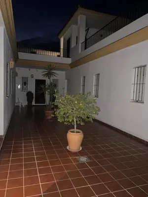 a hallway with potted plants in a building at Casa vacacional equipada in Lebrija