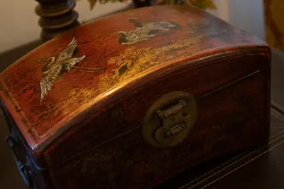 a woodenasket with birds on it sitting on a table at Acogedor Piso Centro Sanlucar de Barrameda in Sanlúcar de Barrameda