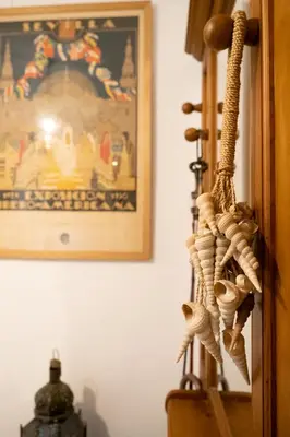 a bunch of rope hanging from a wall with a picture at Acogedor Piso Centro Sanlucar de Barrameda in Sanlúcar de Barrameda