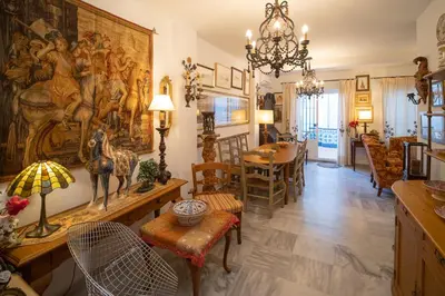 a living room with a large painting on the wall at Acogedor Piso Centro Sanlucar de Barrameda in Sanlúcar de Barrameda