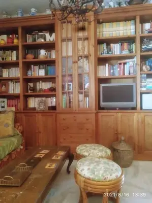 a living room with a tv and a couch and a table at Acogedor Piso Centro Sanlucar de Barrameda in Sanlúcar de Barrameda